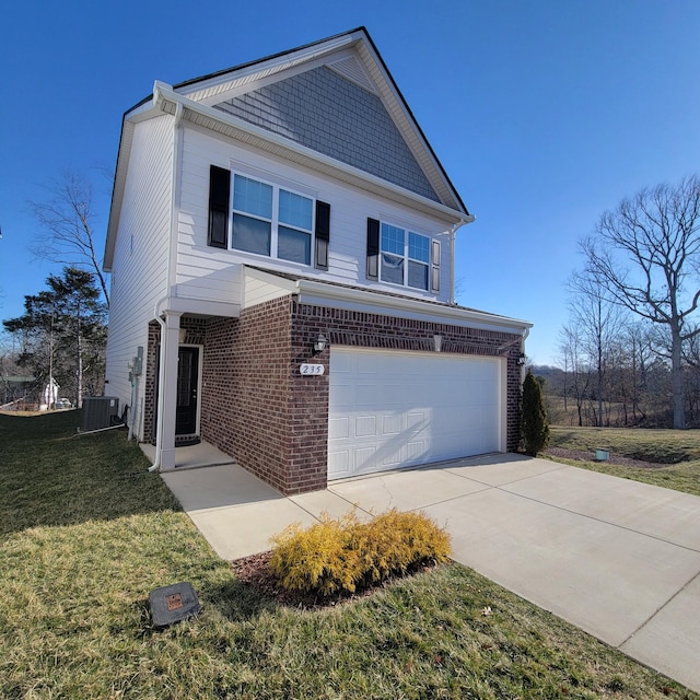 view of front of house with brick siding, an attached garage, a front yard, central AC, and driveway