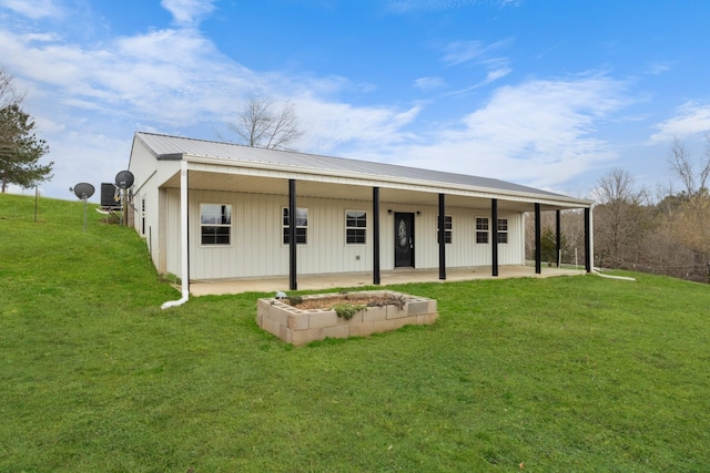 view of front facade featuring metal roof, a front lawn, a patio, and board and batten siding