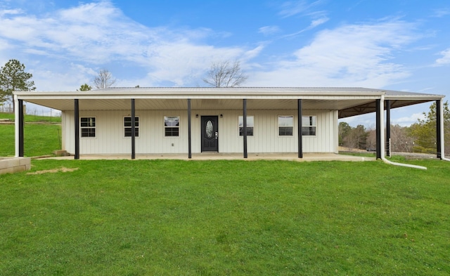 back of house featuring a carport, board and batten siding, and a yard