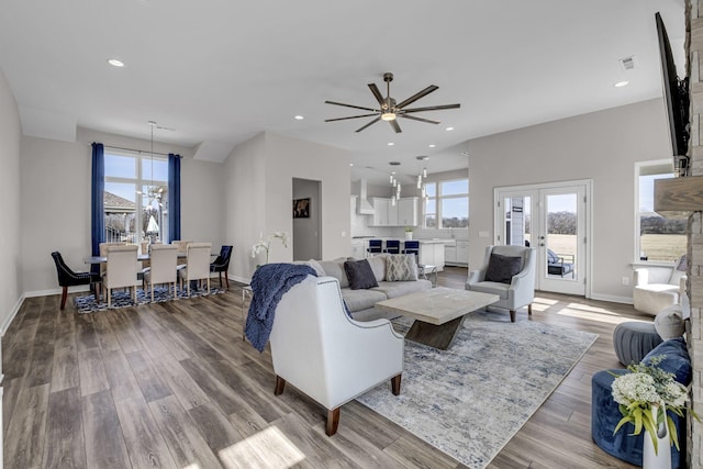 living area with a healthy amount of sunlight, wood finished floors, and recessed lighting