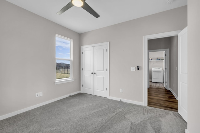 unfurnished bedroom with carpet, a closet, ceiling fan, washer / dryer, and baseboards