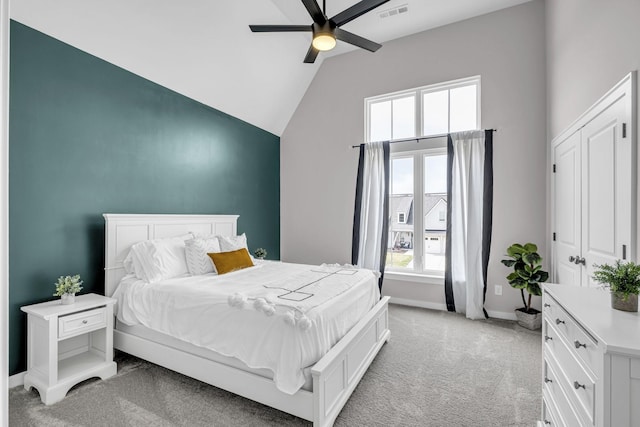 bedroom with light carpet, baseboards, visible vents, a ceiling fan, and lofted ceiling