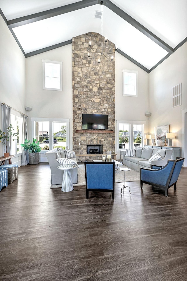 living room with vaulted ceiling with beams, dark wood finished floors, visible vents, and a fireplace