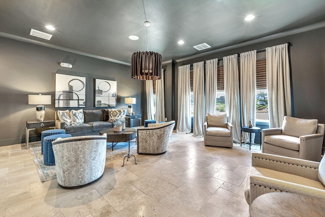 living room featuring stone tile floors, visible vents, baseboards, ornamental molding, and recessed lighting