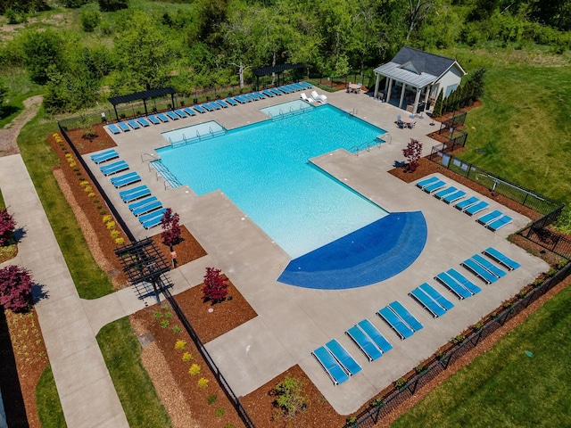 pool featuring fence, a lawn, an outdoor structure, and a patio