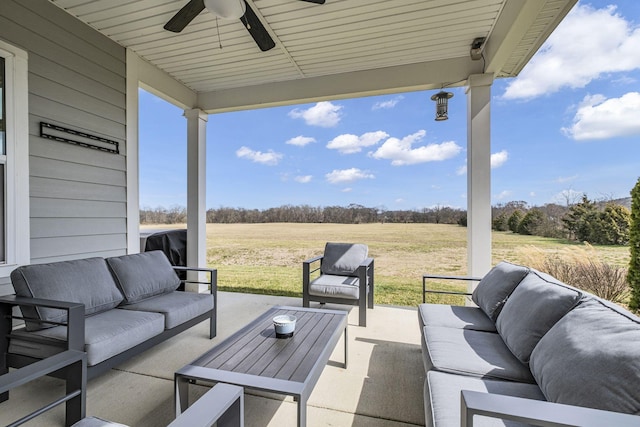 view of patio with a ceiling fan, a rural view, and an outdoor hangout area