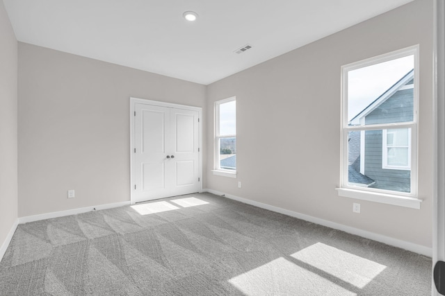 unfurnished bedroom with recessed lighting, baseboards, visible vents, and carpet flooring