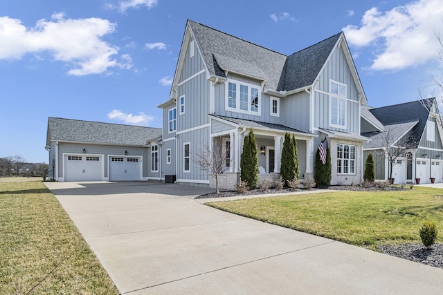 view of front of home featuring an attached garage, a shingled roof, concrete driveway, board and batten siding, and a front yard