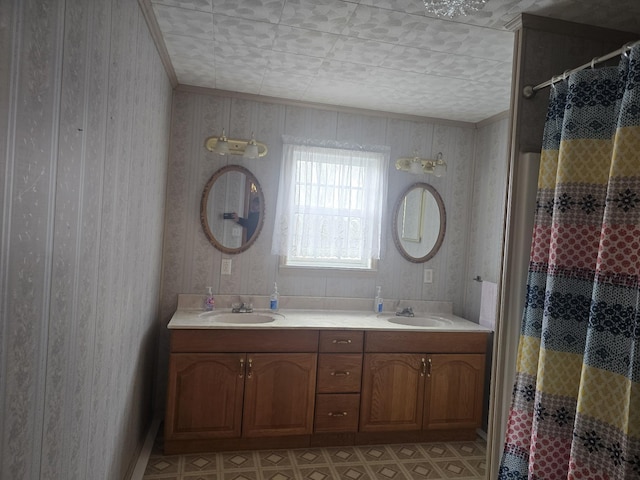 bathroom featuring double vanity, wallpapered walls, a sink, and a shower with shower curtain