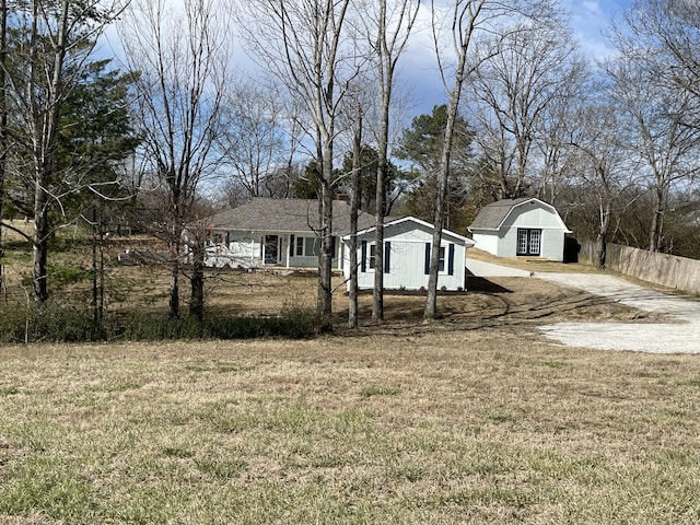 view of yard with driveway and fence