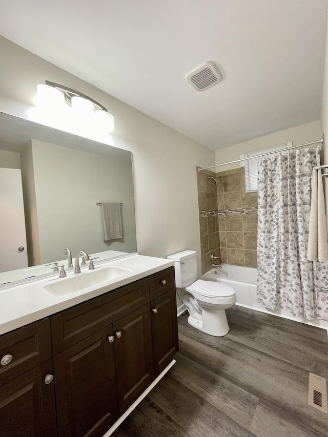 full bathroom featuring toilet, visible vents, wood finished floors, and vanity