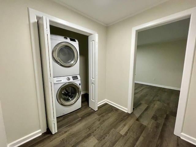 laundry room with laundry area, baseboards, stacked washer / dryer, dark wood-style flooring, and crown molding