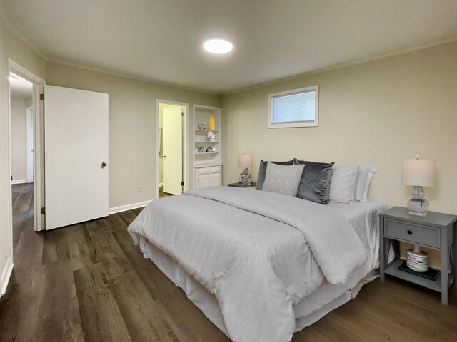 bedroom featuring wood finished floors and baseboards