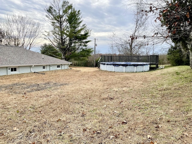 view of yard with a covered pool