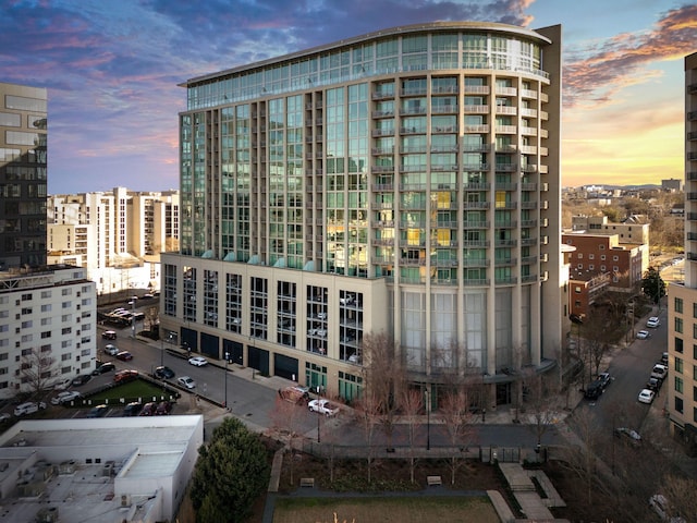 property at dusk featuring a city view