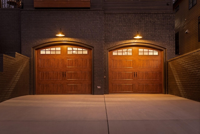 garage featuring concrete driveway