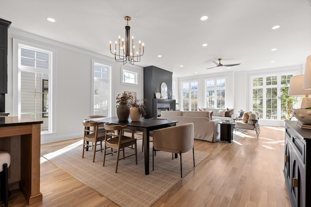 dining room featuring light wood finished floors, baseboards, a ceiling fan, and recessed lighting