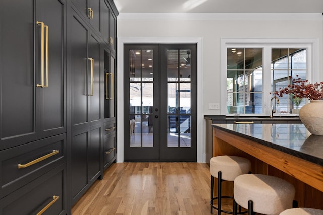 doorway featuring light wood-style floors, a sink, and french doors