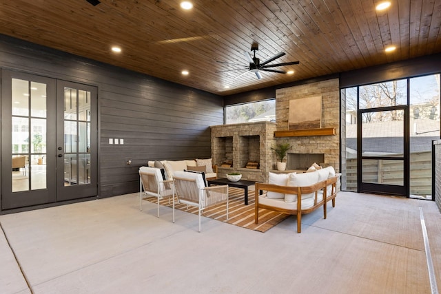 sunroom with wood ceiling, a wealth of natural light, and french doors