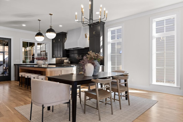 dining area with ornamental molding, recessed lighting, and light wood-style flooring