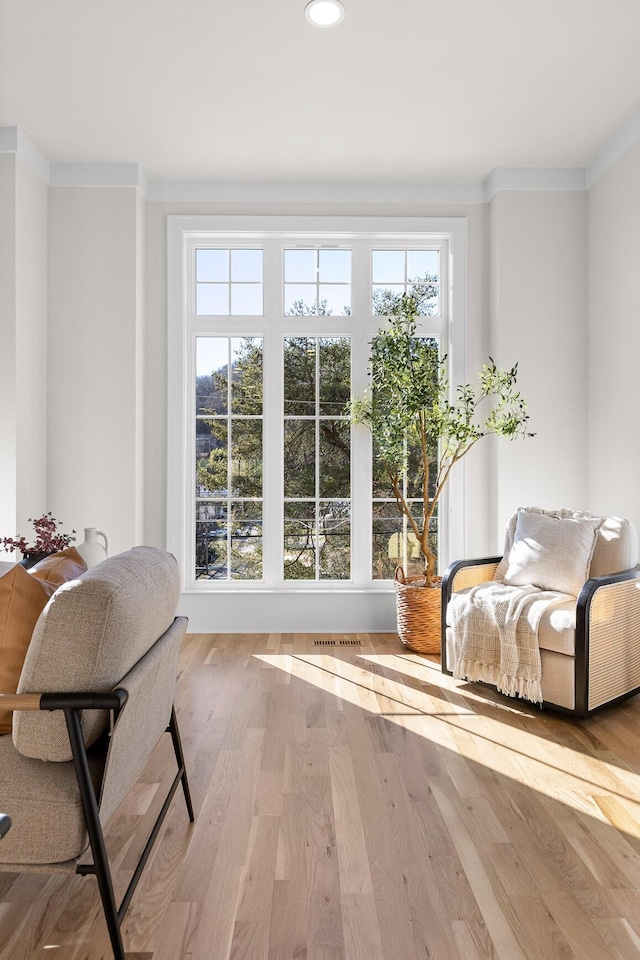 entryway with a wealth of natural light, ornamental molding, wood finished floors, and recessed lighting