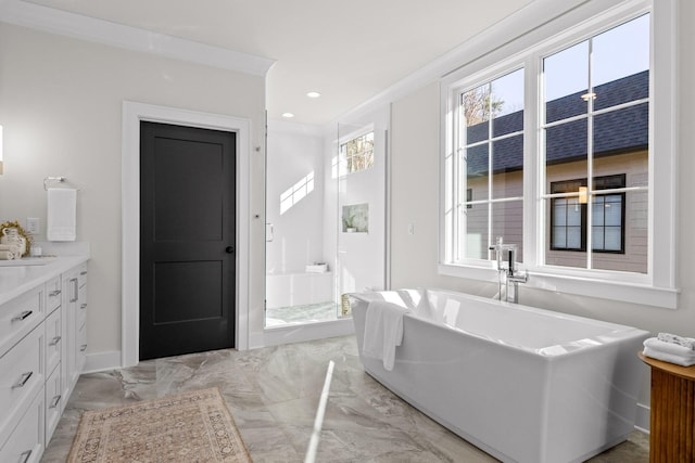 full bath with marble finish floor, recessed lighting, a freestanding bath, vanity, and baseboards