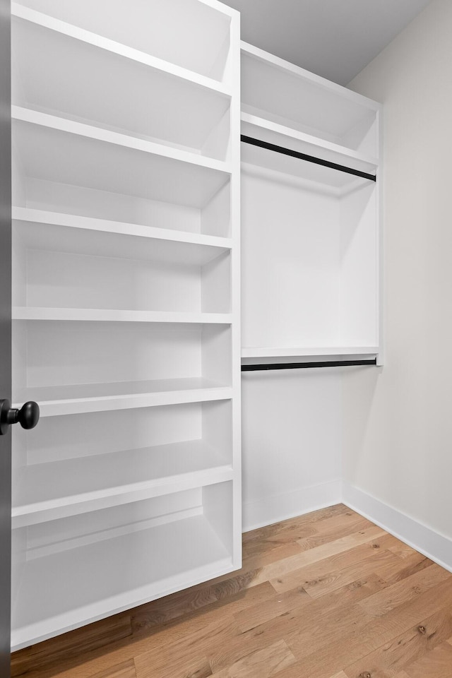 spacious closet featuring wood finished floors