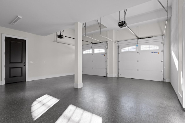 garage featuring a garage door opener and baseboards