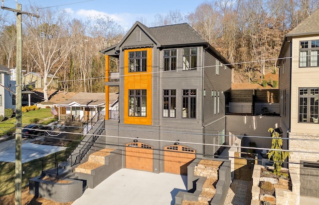 exterior space featuring roof with shingles