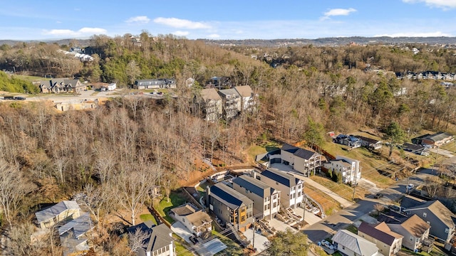 bird's eye view with a wooded view and a residential view