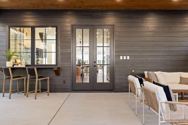 doorway to property with a patio, french doors, and outdoor lounge area