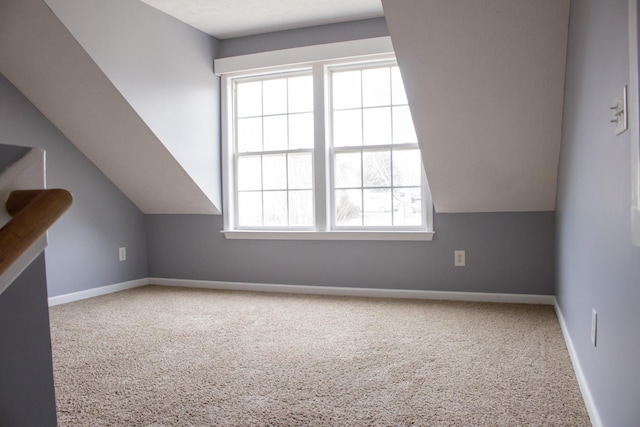 bonus room featuring carpet flooring, vaulted ceiling, and baseboards