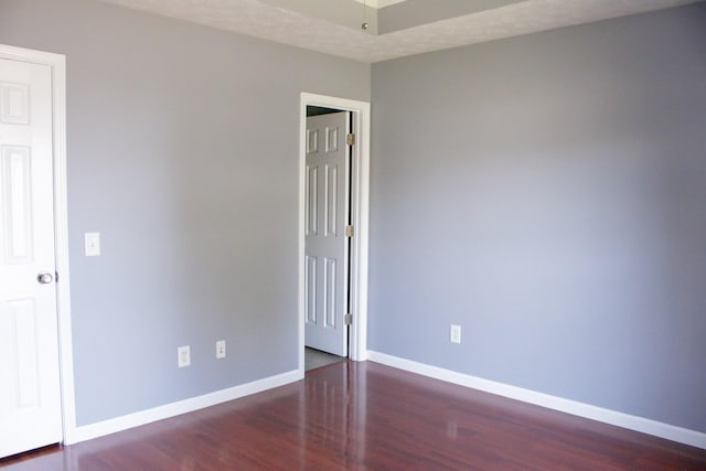 unfurnished room with wood finished floors and baseboards