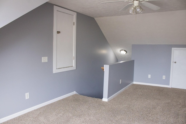 additional living space with lofted ceiling, carpet flooring, and baseboards