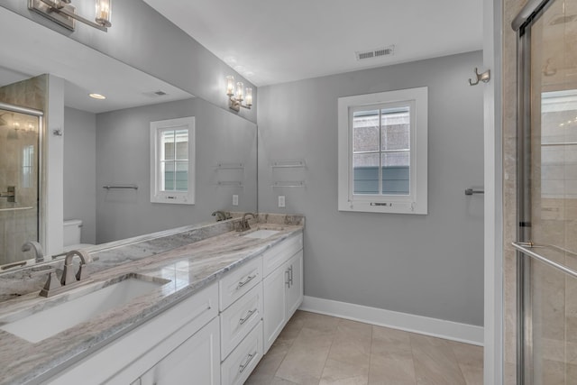 full bathroom with toilet, a shower stall, visible vents, and a sink