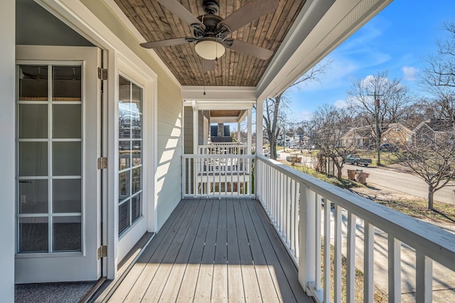 wooden terrace with ceiling fan and a residential view