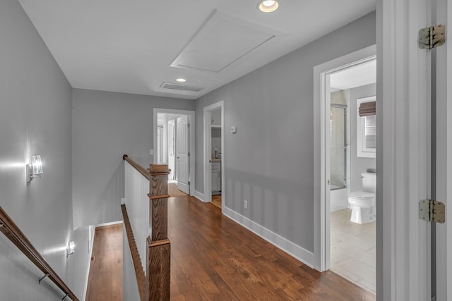 corridor featuring recessed lighting, an upstairs landing, baseboards, dark wood-style floors, and attic access