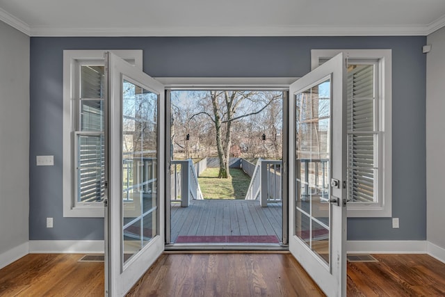 doorway featuring ornamental molding, french doors, wood finished floors, and a healthy amount of sunlight