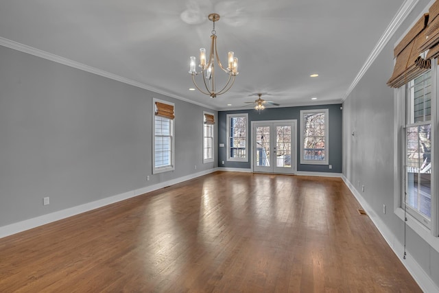 empty room with ornamental molding, french doors, baseboards, and wood finished floors