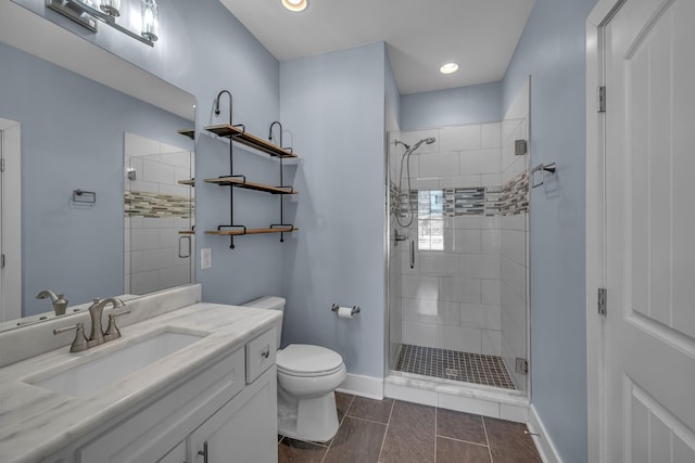 full bath featuring toilet, recessed lighting, vanity, baseboards, and a shower stall