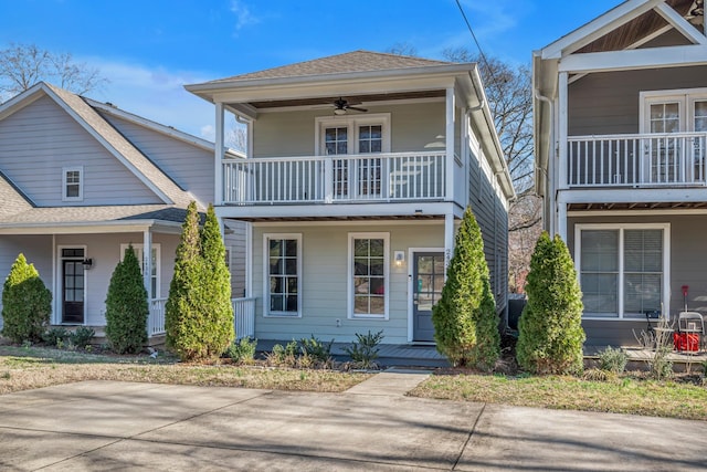 view of front of property with a ceiling fan and roof with shingles