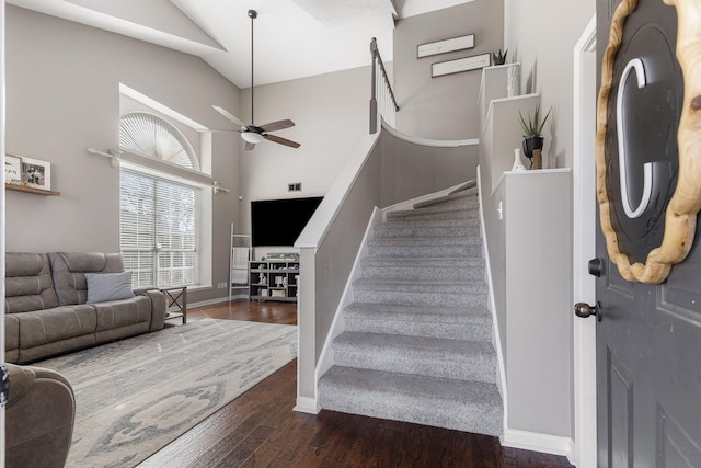 interior space featuring high vaulted ceiling, wood finished floors, baseboards, and ceiling fan