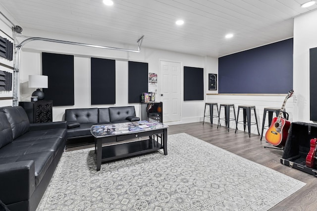 living area with wooden ceiling, recessed lighting, wood finished floors, and a garage