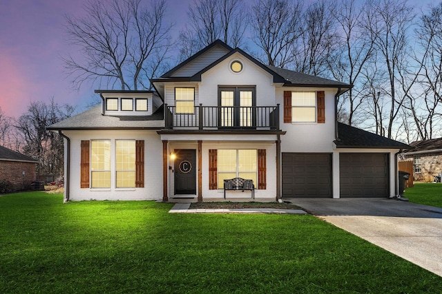 view of front of property featuring a yard, a balcony, concrete driveway, and brick siding