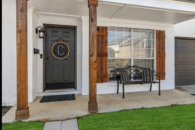 entrance to property featuring brick siding