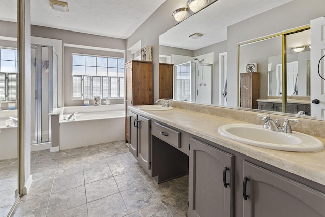 bathroom with a sink, a stall shower, double vanity, and a bath