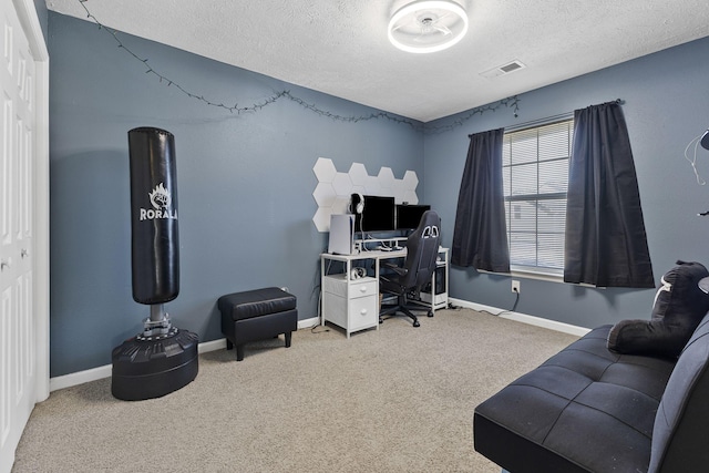 home office featuring visible vents, carpet floors, a textured ceiling, and baseboards