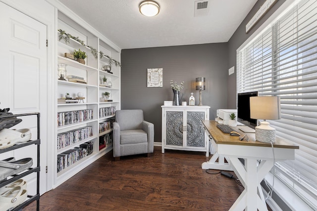 office area featuring visible vents, a textured ceiling, and wood finished floors