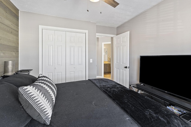 bedroom featuring a closet, wood walls, and ceiling fan