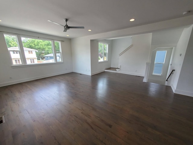 spare room with baseboards, dark wood finished floors, and recessed lighting